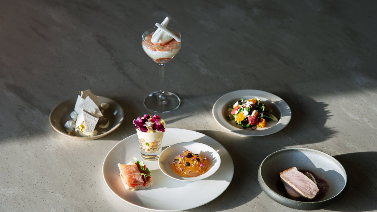 A selection of plated tasting-menu dishes on a restaurant table