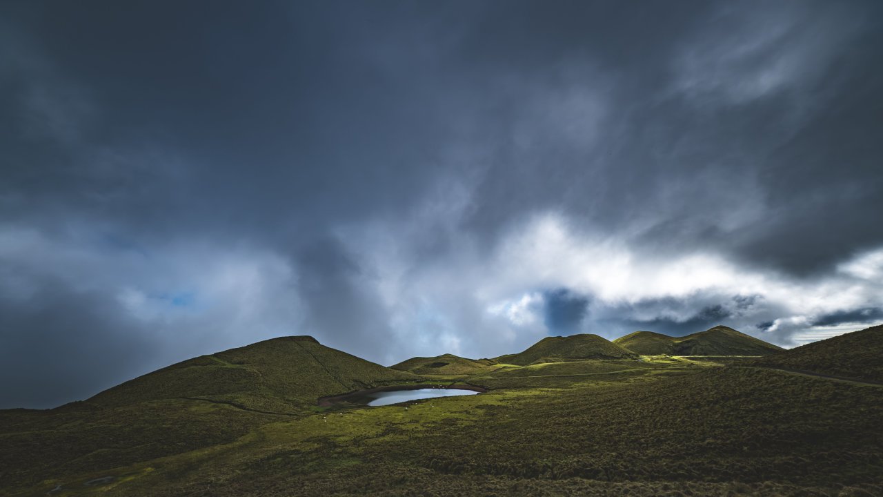 Moody green hills beneath a dramatic stormy sky