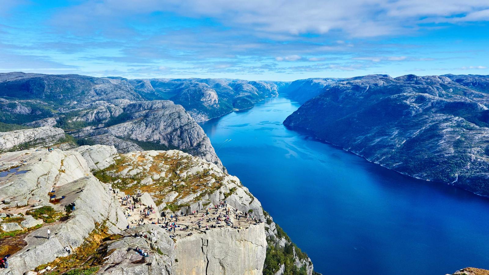 Aerial view of a blue fjord between steep cliffs