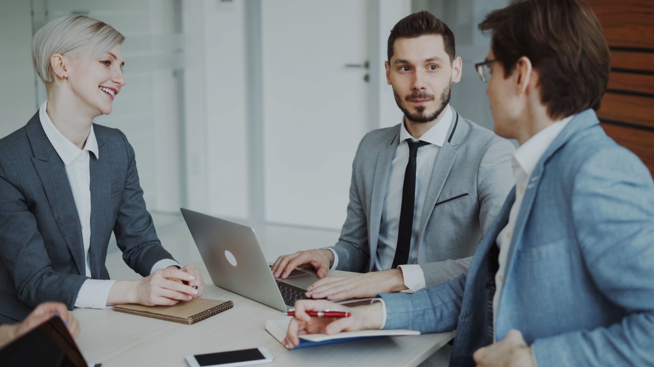 Professional team discussing a web development project at a business meeting