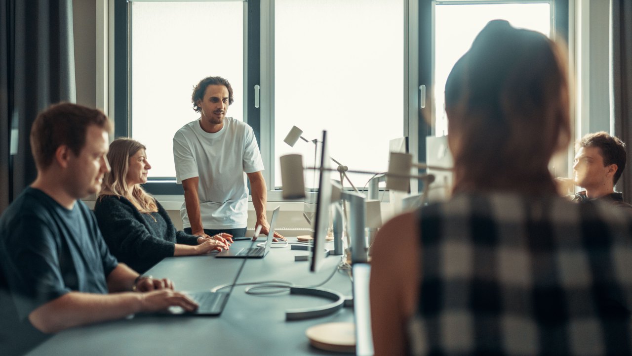 Web development team collaborating in a bright modern office