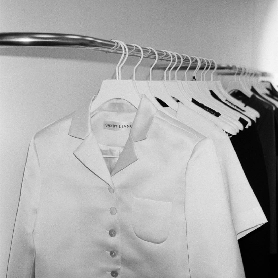 White blouse on a clothing rack in a fashion store
